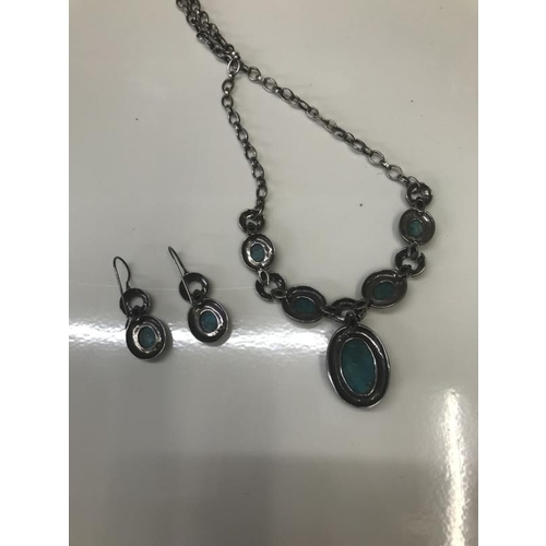 1071 - An engraved silver necklace with matching earrings set with Turquoise coloured stones