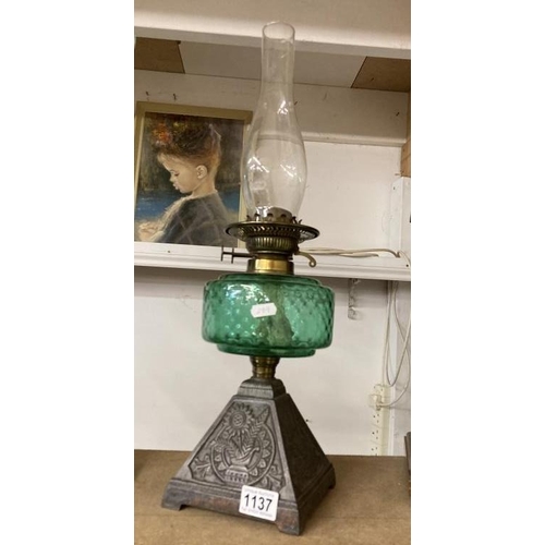 1137 - A Victorian oil lamp with green glass shade