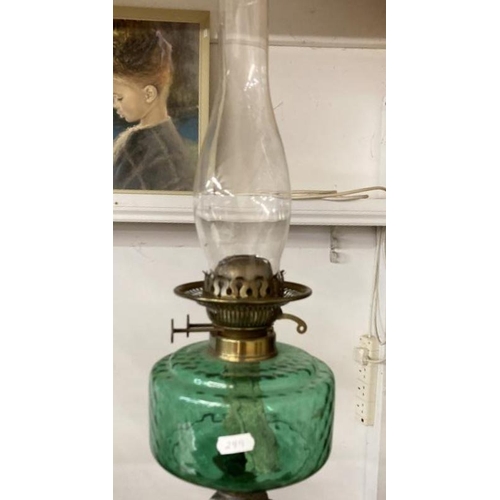 1137 - A Victorian oil lamp with green glass shade