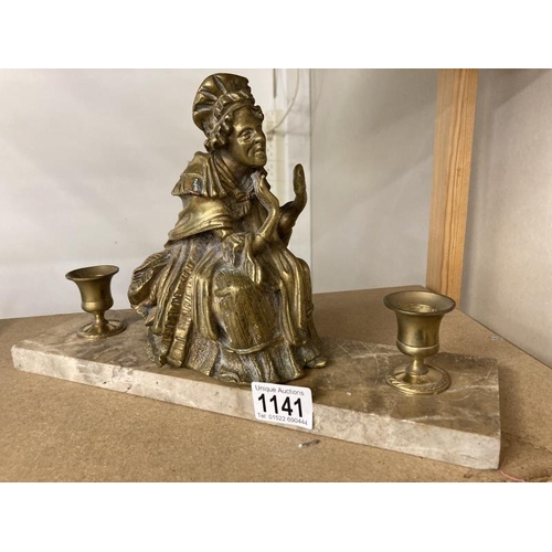 1141 - A brass figured candle stand on polished stone base