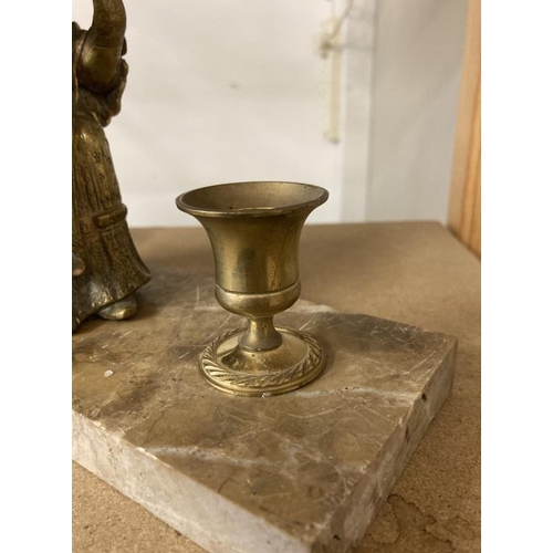 1141 - A brass figured candle stand on polished stone base