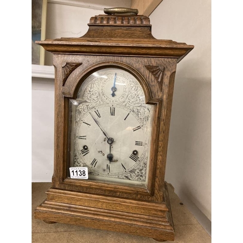 1138 - An oak cased mantel clock with silvered dial, COLLECT ONLY.