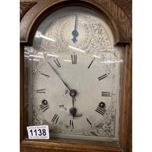 1138 - An oak cased mantel clock with silvered dial, COLLECT ONLY.