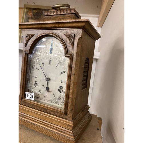 1138 - An oak cased mantel clock with silvered dial, COLLECT ONLY.