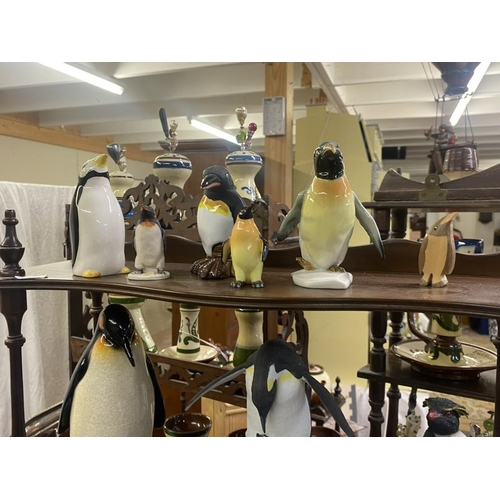 1496 - A collection of penguin figures, pottery, china, wood etc