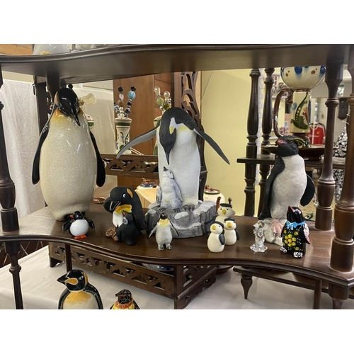 1496 - A collection of penguin figures, pottery, china, wood etc