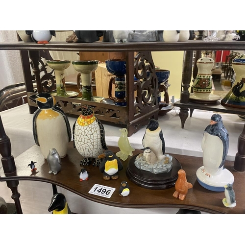 1496 - A collection of penguin figures, pottery, china, wood etc