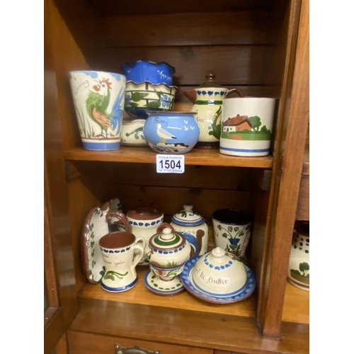 1504 - A quantity of Torquay ware including butter dish, sugar bowls etc