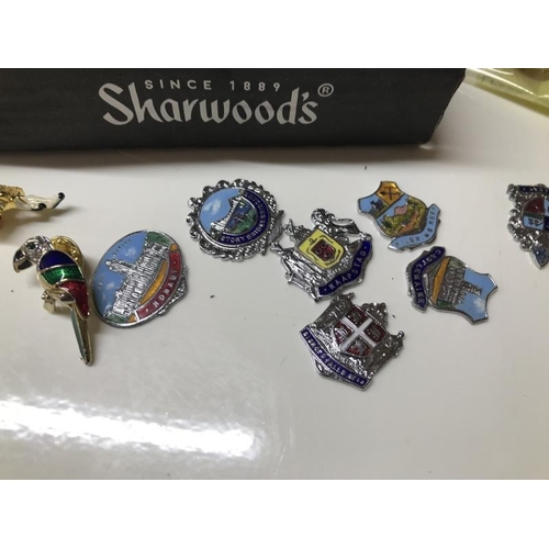 1460L - A collection of badges, sliver charms & other charms. Walking stick badges & Silver Jubilee souvenir... 