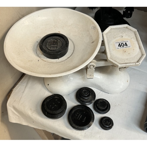 404 - A set of cast iron kitchen scales & weights