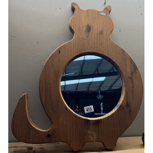 413 - A large pine framed cat shaped mirror