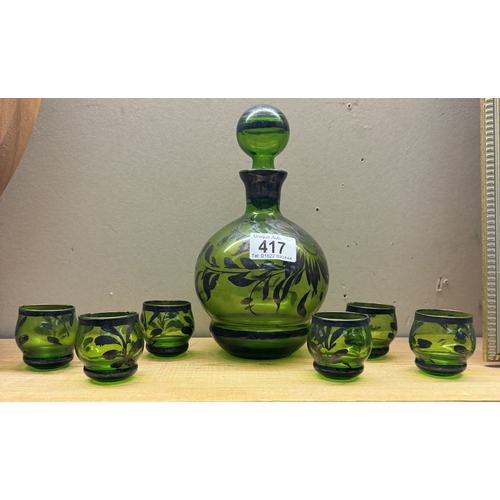 417 - A vintage overlaid green glass decanter & 6 shot glasses