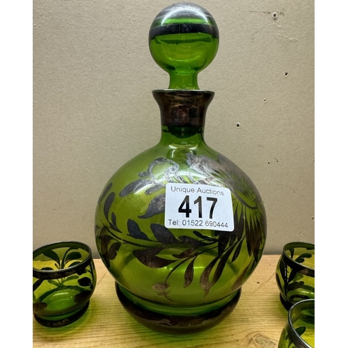 417 - A vintage overlaid green glass decanter & 6 shot glasses