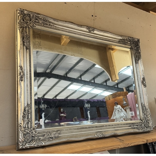 432 - An ornate silver coloured bevel edged mirror (64 x 84cm) COLLECT ONLY