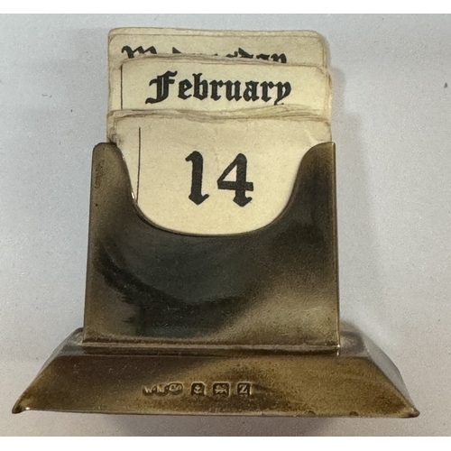 506 - A silver perpetual desk calendar and a brass example.