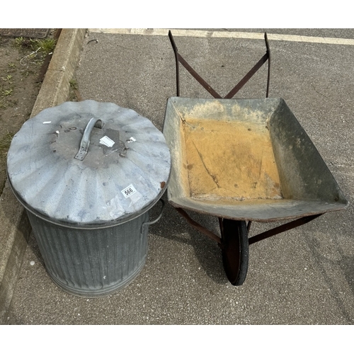 566 - A metal dustbin with metal wheelbarrow