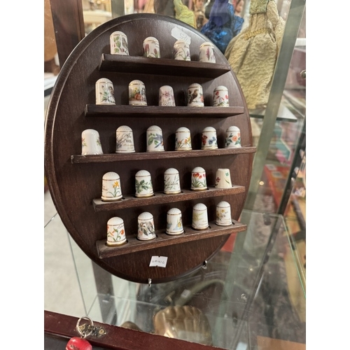 664 - A quantity of thimbles on shelf & a small jewellery cabinet