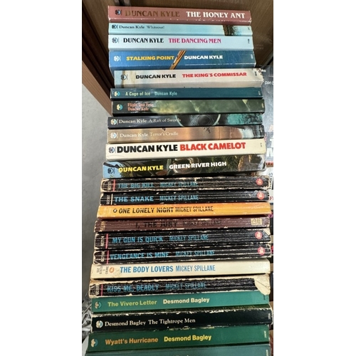 677 - A good lot of paperback books by Travis McGee, John D.Mcdonald, Desmond Bagley, Mickey Spillane & Du... 