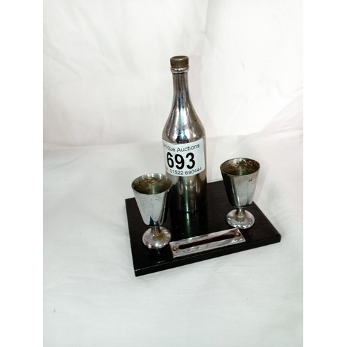 693 - An art deco striker lighter of a champagne bottle & goblets