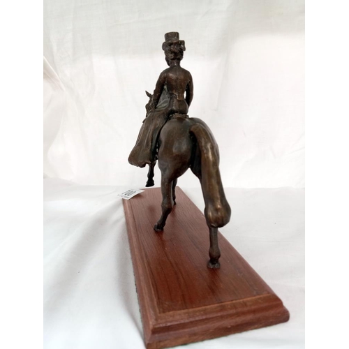 700 - A bronze Edwardian dressed lady on horse