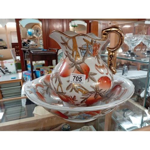 705 - A peach decorative jug & wash bowl