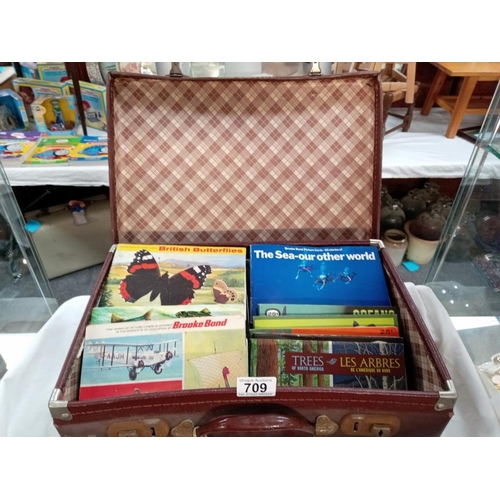 709 - A vintage suitcase of Brooke Bond tea cards & books