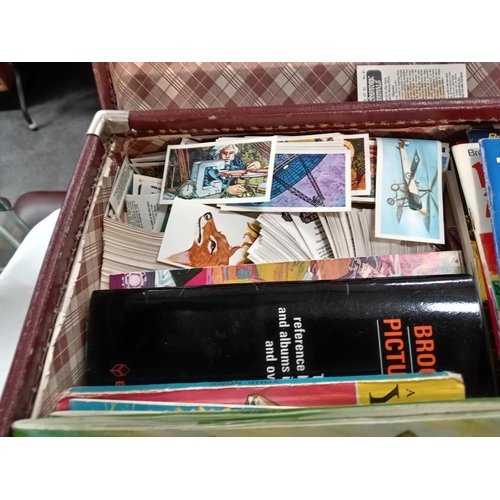 709 - A vintage suitcase of Brooke Bond tea cards & books