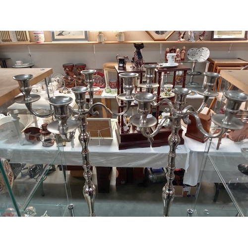 723 - A pair of modern white metal candelabras