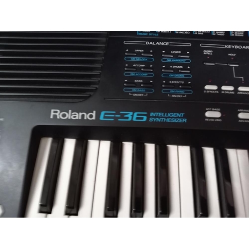 727 - A 'Roland' E36 intelligent synthesizer including power unit & carrying bag