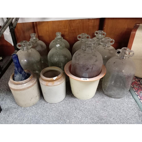 729 - A quantity of stoneware jars & glass demi john etc.