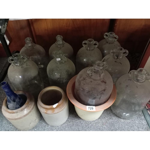 729 - A quantity of stoneware jars & glass demi john etc.