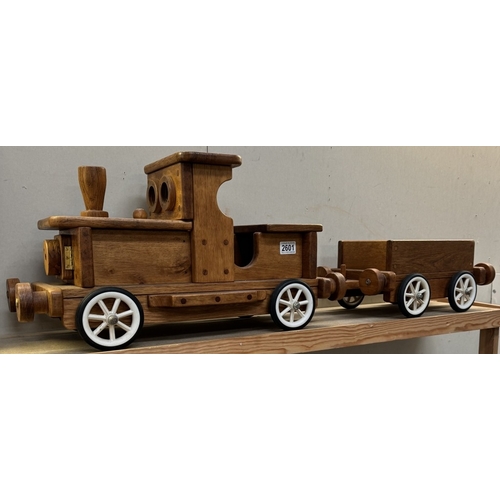 2601 - A large wooden pull along train & trailer. Total length 105cm