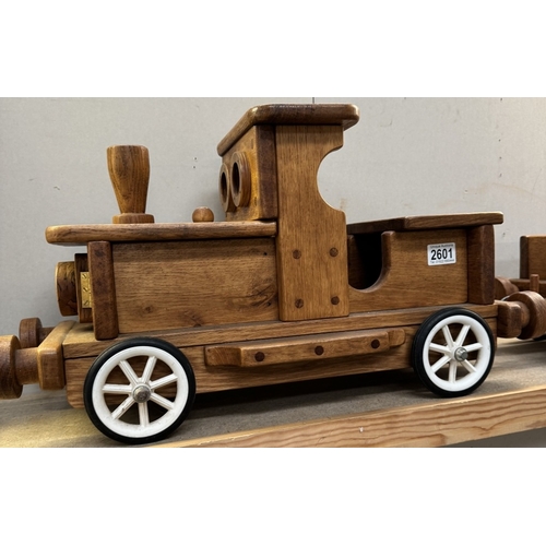 2601 - A large wooden pull along train & trailer. Total length 105cm