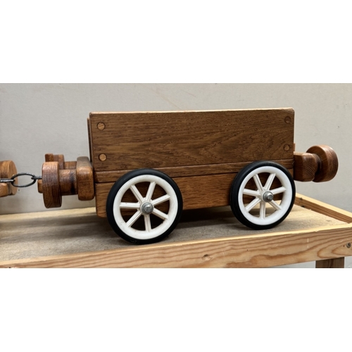 2601 - A large wooden pull along train & trailer. Total length 105cm