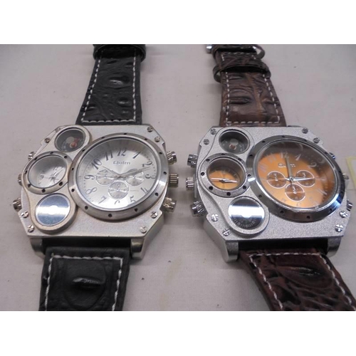 1103 - Two OULM multi-functional wrist watches, sold as seen.