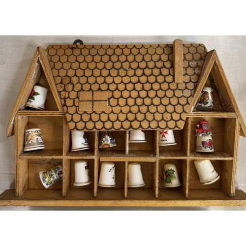 2645 - A quantity of porcelain thimbles & a small display shelf