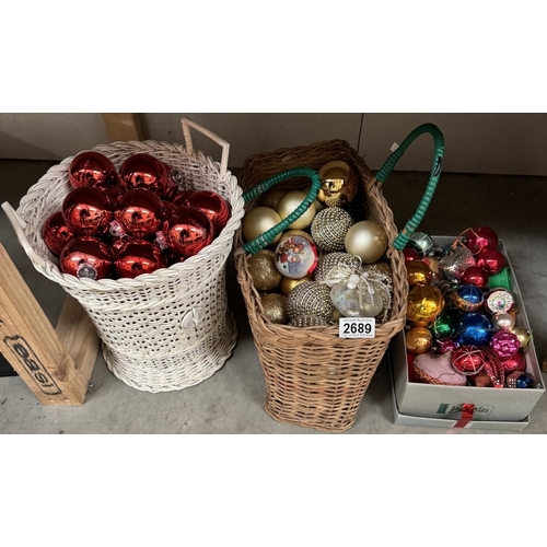 2689 - A quantity of Christmas baubles. ( 2 Wicker baskets & A shoe box)