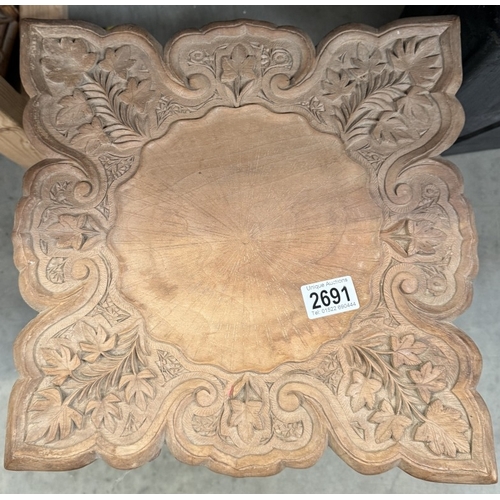 2691 - A carved wood side table