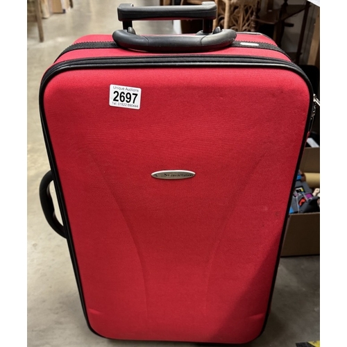 2697 - A red fabric covered constellation suitcase on wheels