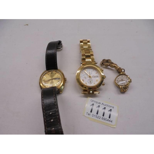 1111 - A Garrard date watch, a ladies Everite Junior watch and one other.