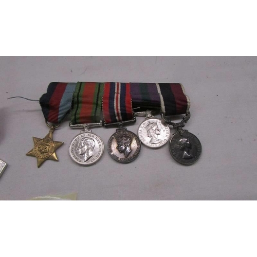 1131 - Two sets of miniature medals (nine in total).