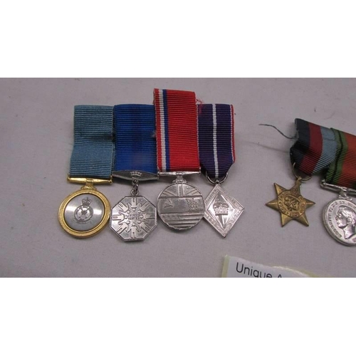 1131 - Two sets of miniature medals (nine in total).