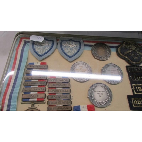 1134 - A cased collection of Royal Air Force Small Arms association medals and badges.