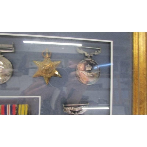 1135 - A framed and glazed cased medal display from Lesley Lorking including Africa General Service medal w... 