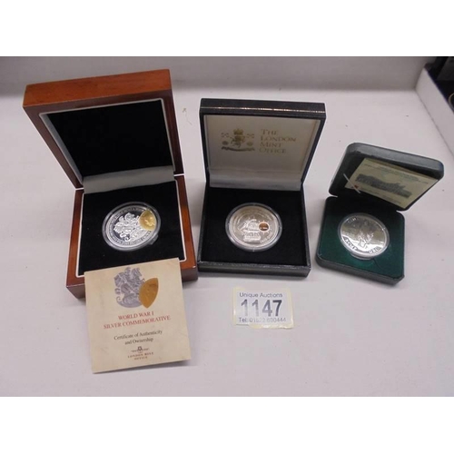 1147 - A WW1 silver commemorative St. George coin in case, a 2005 Cook Islands silver Trafalgar coin & 1998... 