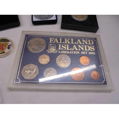 1148 - A mixed lot of collector's coins including Falkland Islands, cases set of 'V Force' etc.,