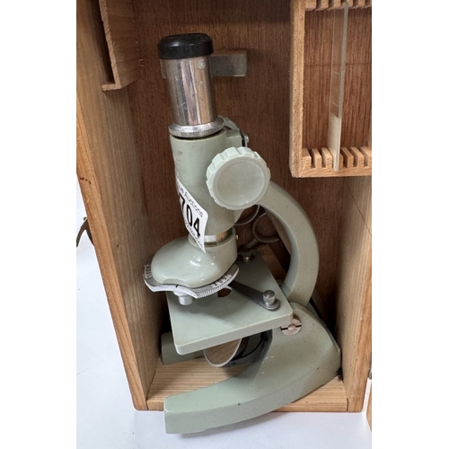 2704 - A childs mirrored microscope in a wooden box