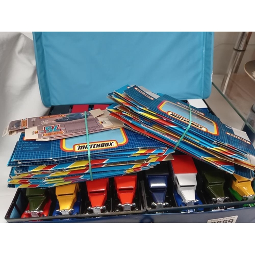 2889 - A Matchbox carry case with 48 MB38 model A Ford vans & 32 empty boxes. In mint condition