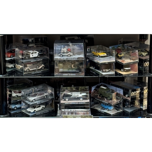 43 - A collection of 111 James Bond collectors cars & magazines