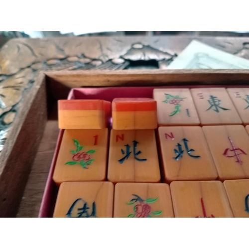 75 - A beautiful carved box comprising of a mahjong set